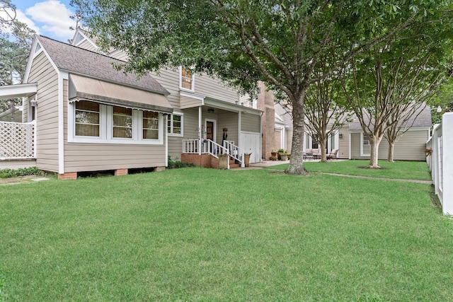 1075 Thomas Rd, Beaumont, TX 77706 - rear view of house featuring roof with shingles and a lawn