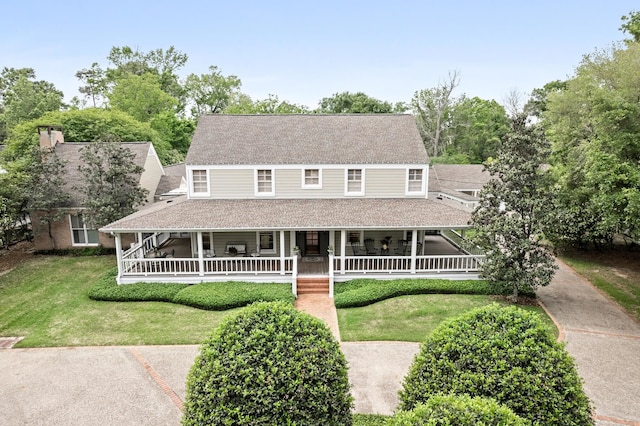 country-style home with a front yard and a porch