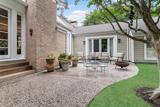 view of patio / terrace with an outdoor living space with a fire pit