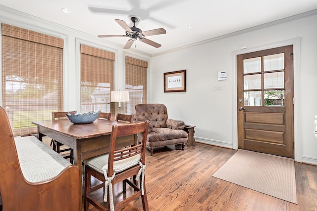 dining space featuring ceiling fan, crown molding, and wood-type flooring