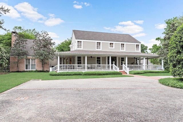 farmhouse-style home with a porch and a front lawn