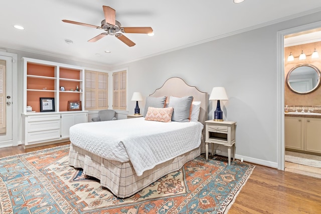 bedroom featuring ensuite bath, ceiling fan, crown molding, and light hardwood / wood-style floors