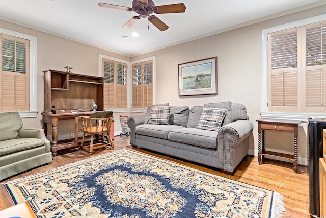 living room featuring ceiling fan, hardwood / wood-style flooring, and ornamental molding