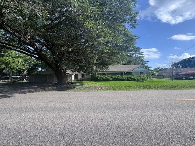 10265 Phelan Blvd, Beaumont, TX 77713 - view of front of house with a garage and a front lawn