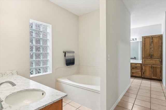 bathroom with tile patterned floors, vanity, and a bath