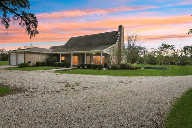 view of front of house with a yard and a garage