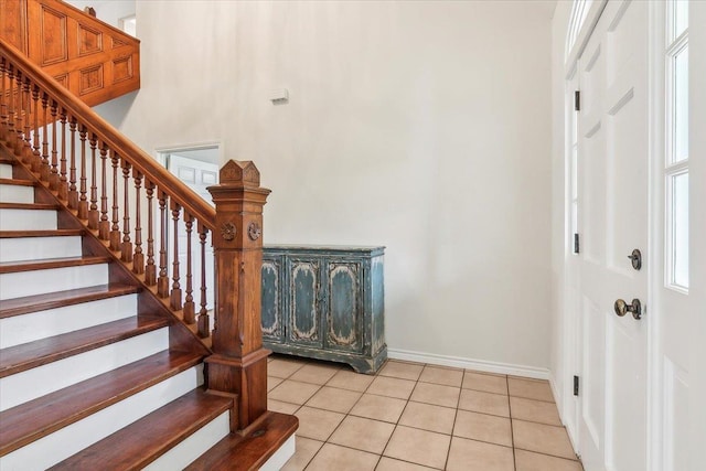 stairway featuring tile patterned flooring