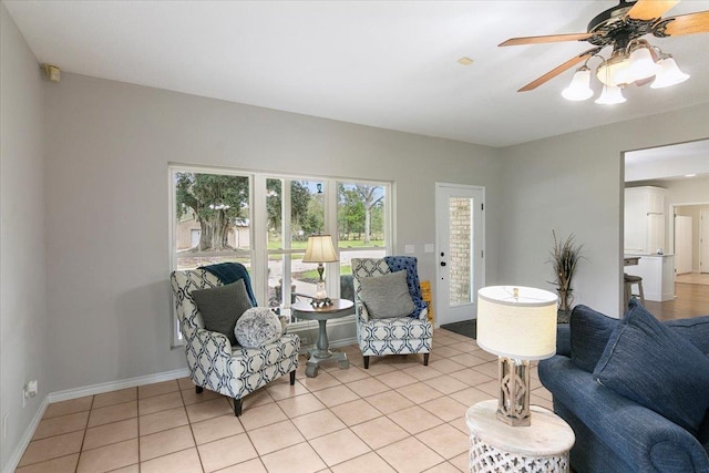 living area featuring ceiling fan and light tile patterned floors