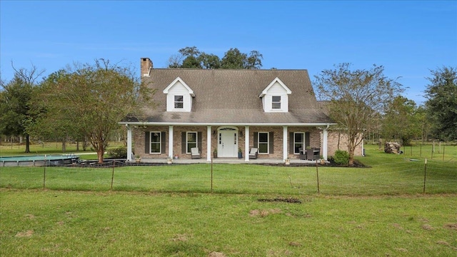 cape cod home with a front yard