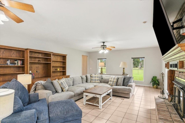 tiled living room with ceiling fan and a brick fireplace