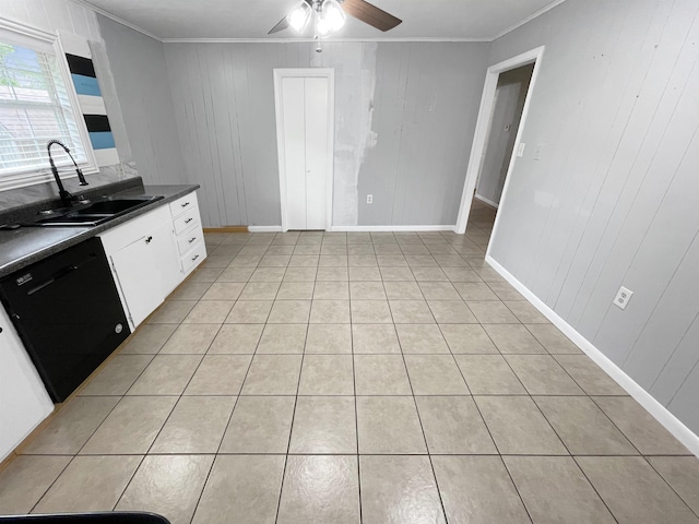 kitchen featuring dishwasher, sink, light tile patterned floors, crown molding, and white cabinets