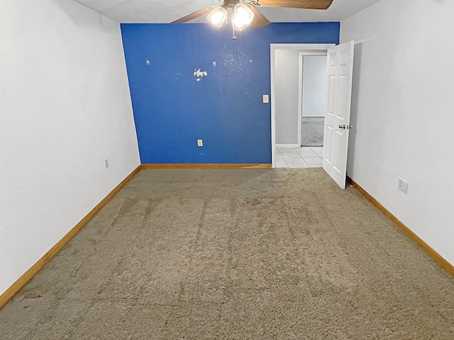 empty room featuring light carpet and ceiling fan