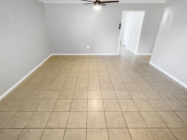 tiled empty room featuring ceiling fan