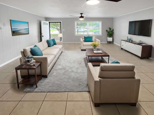 living room with wood walls, light tile patterned floors, and ceiling fan