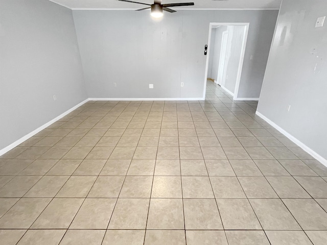 tiled spare room with ceiling fan and ornamental molding