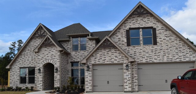 view of front of property featuring central air condition unit and a garage