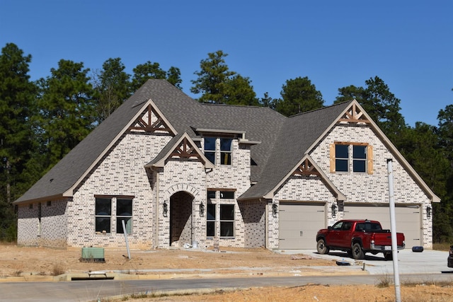 view of front of property featuring central air condition unit and a garage