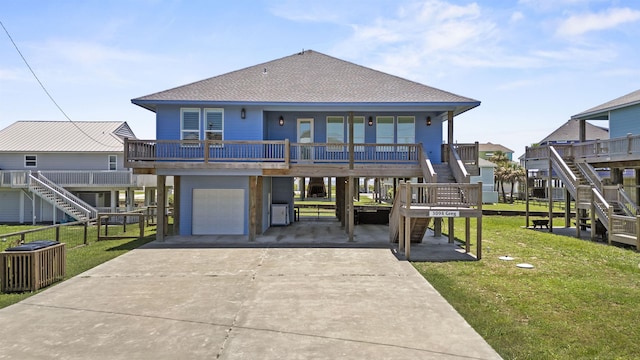 view of front of house with a carport, a porch, a garage, and a front lawn