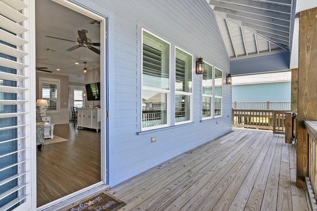 wooden terrace featuring ceiling fan