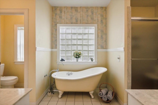 full bathroom featuring tile patterned floors, vanity, and a healthy amount of sunlight