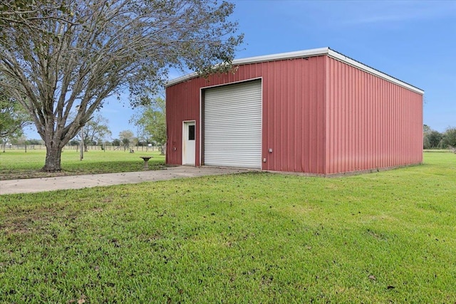 view of outdoor structure featuring a yard and a garage