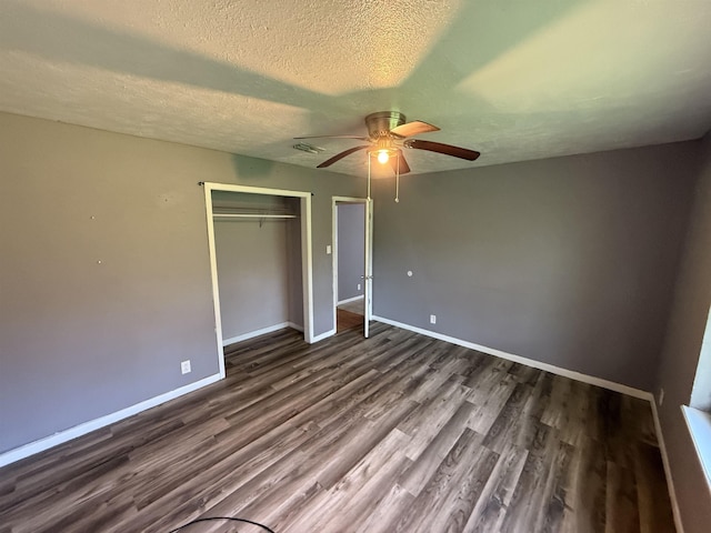 5085 Plant Rd, Beaumont, TX 77708 - unfurnished bedroom featuring wood finished floors, a closet, a ceiling fan, and a textured ceiling