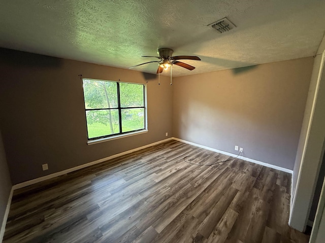 5085 Plant Rd, Beaumont, TX 77708 - unfurnished room with dark wood finished floors, a ceiling fan, and a textured ceiling