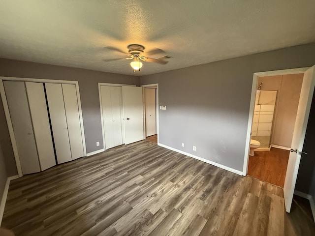 5085 Plant Rd, Beaumont, TX 77708 - unfurnished bedroom with multiple closets, wood finished floors, a textured ceiling, ensuite bath, and a ceiling fan