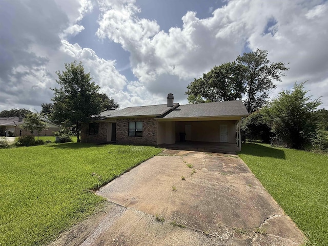 5085 Plant Rd, Beaumont, TX 77708 - ranch-style house featuring concrete driveway, an attached carport, a front lawn, and a chimney