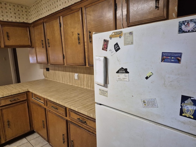 kitchen featuring light tile patterned floors and white refrigerator