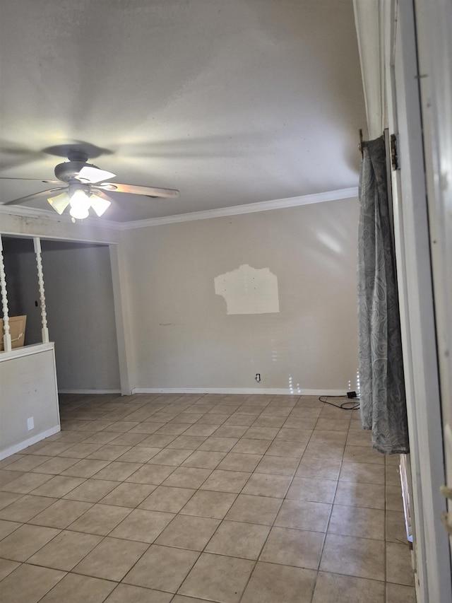 tiled empty room featuring ceiling fan and ornamental molding