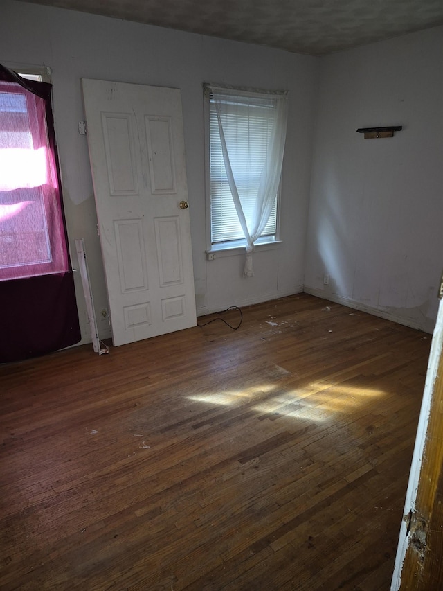 spare room with dark wood-type flooring