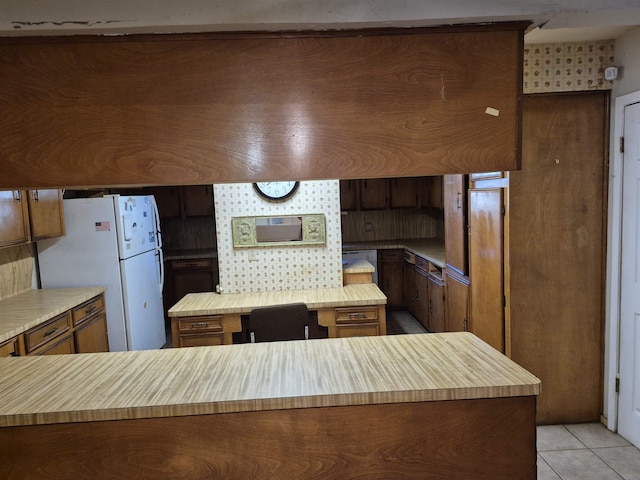 kitchen featuring light tile patterned floors and white fridge