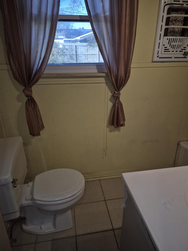 bathroom with tile patterned flooring, vanity, and toilet