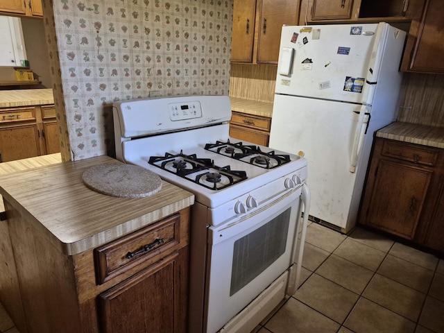 kitchen with light tile patterned floors and white appliances