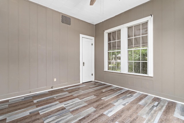 4300 Ferndale Dr, Port Arthur, TX 77642 - spare room with wood finished floors, a ceiling fan, and a decorative wall