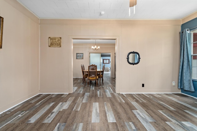 4300 Ferndale Dr, Port Arthur, TX 77642 - dining room with crown molding, wood finished floors, a chandelier, and a decorative wall