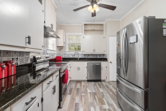 4300 Ferndale Dr, Port Arthur, TX 77642 - kitchen with stainless steel appliances, exhaust hood, a ceiling fan, light wood finished floors, and backsplash
