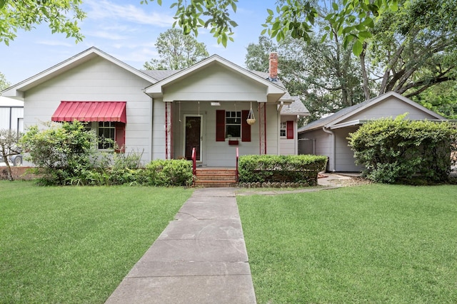 4300 Ferndale Dr, Port Arthur, TX 77642 - view of front of house with a front lawn, a porch, and a chimney