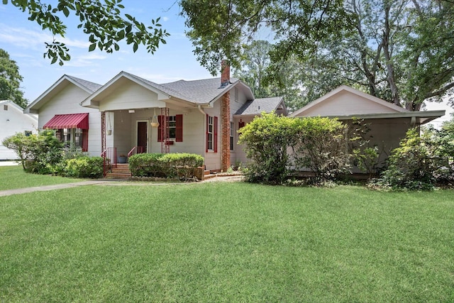 4300 Ferndale Dr, Port Arthur, TX 77642 - bungalow-style home featuring a chimney, a front lawn, a shingled roof, and covered porch