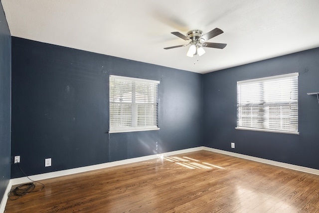 unfurnished room with hardwood / wood-style flooring and ceiling fan