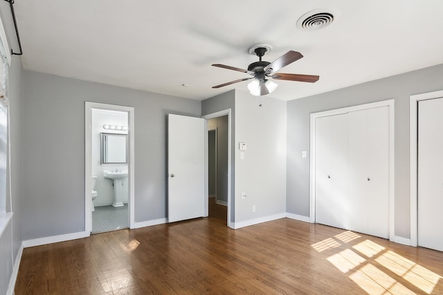 unfurnished bedroom with connected bathroom, hardwood / wood-style floors, and ceiling fan