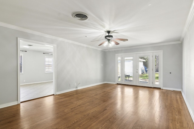 spare room featuring wood-type flooring, ornamental molding, ceiling fan, and french doors