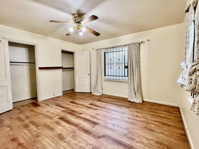 unfurnished bedroom with ceiling fan and light wood-type flooring