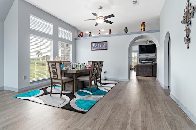 200 Skylark Ave, Bridge City, TX 77611 - dining space with ceiling fan, arched walkways, and wood finished floors