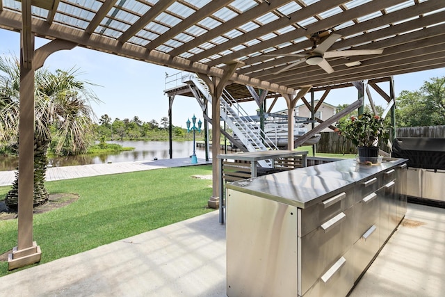 200 Skylark Ave, Bridge City, TX 77611 - view of patio featuring a water view, a ceiling fan, an outdoor kitchen, and a pergola