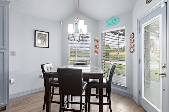 200 Skylark Ave, Bridge City, TX 77611 - dining room featuring a chandelier, vaulted ceiling, and light wood-style flooring
