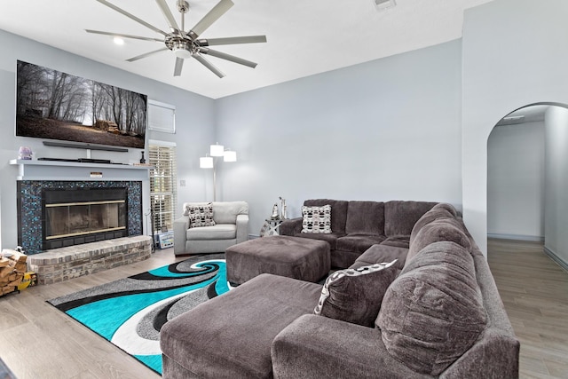 200 Skylark Ave, Bridge City, TX 77611 - living area with arched walkways, wood finished floors, a ceiling fan, and a brick fireplace