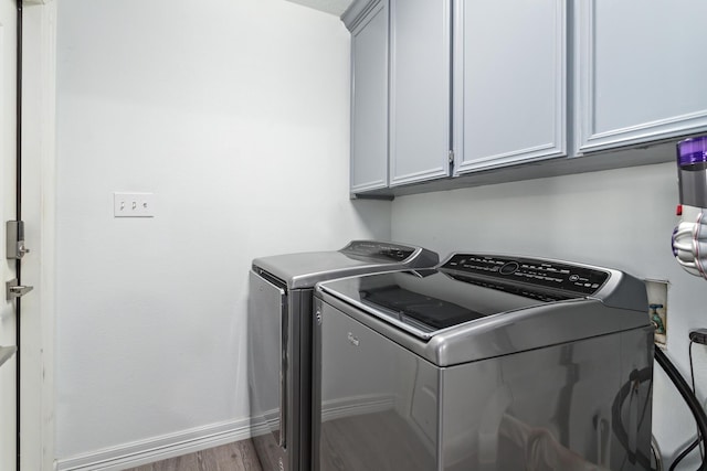 200 Skylark Ave, Bridge City, TX 77611 - laundry room with washing machine and clothes dryer, cabinet space, and wood finished floors