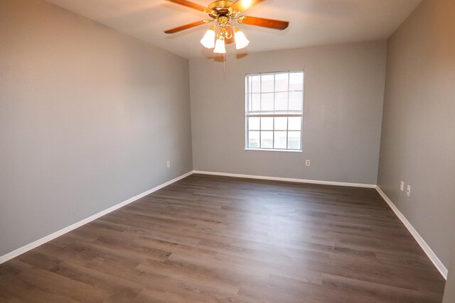 8720 Glen Mdw, Beaumont, TX 77706 - spare room featuring ceiling fan, dark wood finished floors, and baseboards